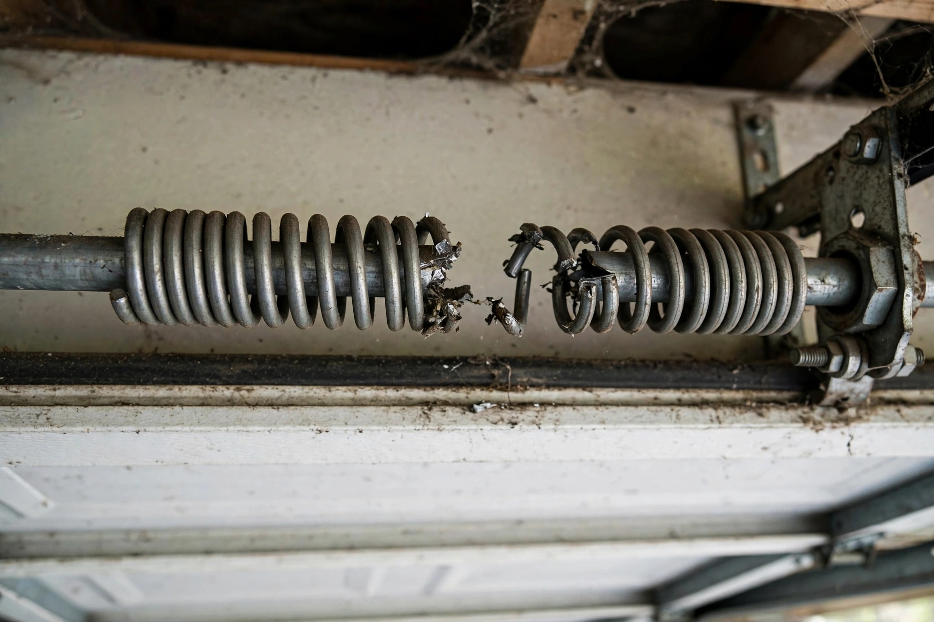 Close-up of a broken garage door torsion spring in Franklin TN